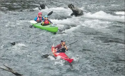  ??  ?? Shooting the rapids with Melanie Grant paddling security.