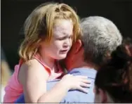  ?? RAINIER EHRHARDT — THE ASSOCIATED PRESS ?? Lilly Chapman, 8, cries after being reunited with her father, John Chapman at Oakdale Baptist Church on Wednesday in Townville, S.C.