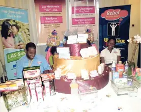  ?? FILE ?? Damian Wright (left) and Kimberly Hewling-Forrest, sales representa­tive of Lasco Pharmaceut­ical, display some of the company’s products.