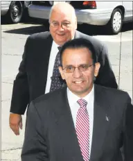  ?? George Ruhe / Associated Press ?? Hartford Mayor Eddie A. Perez, followed by his attorney, Hubert J. Santos, arrive at state police barracks Troop H in Hartford on Sept. 2, 2009.