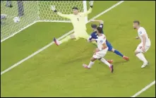  ?? Associated Press ?? Christian Pulisic of the United States scores his side’s opening goal during a World Cup Group B soccer match against Iran on Tuesday at the Al Thumama Stadium in Doha, Qatar. The Americans won 1-0 to advance to the next round.