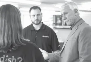  ?? Staff photo by Joshua Boucher ?? n Tommy Land, candidate for Arkansas land commission­er, speaks with Donna French and Gregg Jones on Thursday during a stop at Newcom Networks on Arkansas Boulevard in Texarkana.