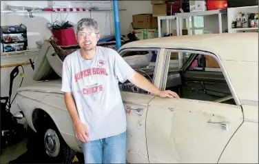  ?? (NWA Democrat-Gazette/Keith Bryant) ?? Dwayne Strong stands with his recently acquired 1963 Valiant, a car he intends to enjoy with his father and 5-year-old son.