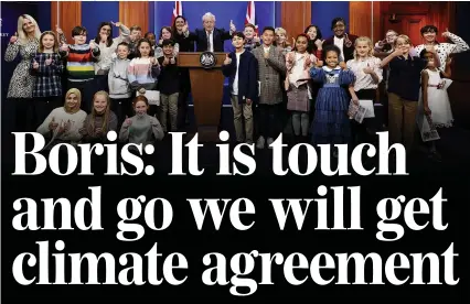  ?? Picture: ANDREW PARSONS/10 DOWNING STREET ?? Thumbs up to the future...Boris with children at yesterday’s Kids’ Climate Press Conference in Downing Street