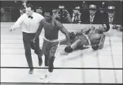  ?? THE ASSOCIATED PRESS -1971 ?? Joe Frazier is directed to his corner by referee Arthur Marcante after knocking down Muhammad Ali during the 15th round of a title fight at Madison Square Garden.