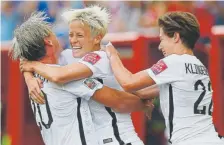  ?? John Woods, The Canadian Press ?? United States’ Megan Rapinoe, center, Abby Wambach, left, and Meghan Klingenber­g played on the 2015 U.S. Women’s World Cup team. Rapinoe and Klingenber­g have started a lifestyle brand with two other American players.