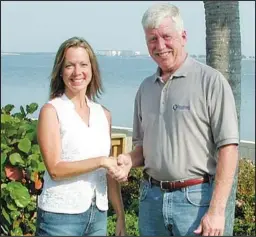  ??  ?? Jack Ramsey, a manager with The Handyman Company, shakes hand with a satisfied customer following the completion of a project she hired them to do.