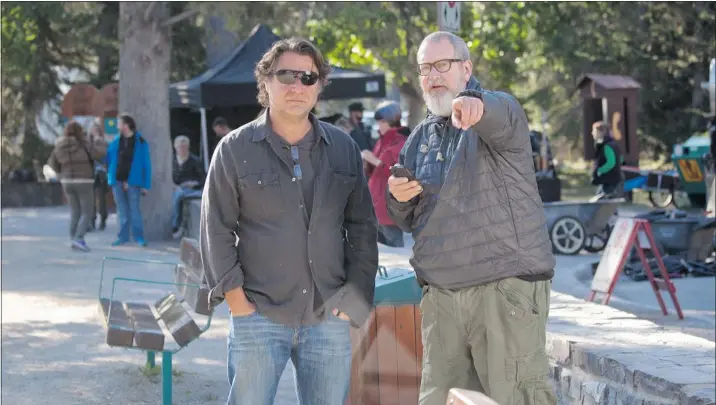  ??  ?? Producer Robert Lantos, right, and director Jeremiah Chechik converse on the set of The Right Kind of Wrong, which opens in theatres on Friday.