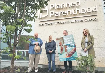  ??  ?? The Rev. Patrick Mahoney (third left), National Director of the Christian Defense Coalition, prays with Stanton Healthcare Founder and CEO Brandi Swindell (right), Mark Roepke (left) of Arlington, Virginia, and Julia Haag (second left) of Springfiel­d,...