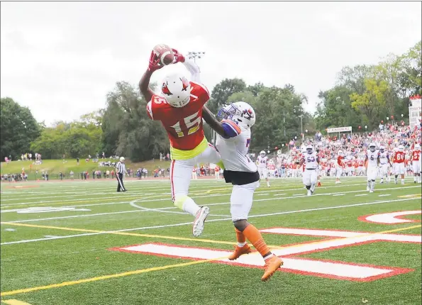  ?? Matthew Brown / Hearst Connecticu­t Media ?? Greenwich’s AJ Barber catches a pass for a touchdown against Danbury’s Xavier Ross in the season opener for both teams in this FCIAC contest at Cardinal Stadium in Greenwich on Saturday.