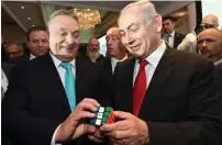  ?? (Haim Zach/GPO) ?? PRIME MINISTER Benjamin Netanyahu and Hungarian Prime Minister Viktor Orban play with a Rubik’s Cube in Budapest in July 2017.