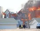  ?? DOUG RAFLIK/USA TODAY NETWORK-WISCONSIN ?? Apartment building 109 of the Village Glen Apartments in Beaver Dam burns under supervisio­n from fire department­s March 15.