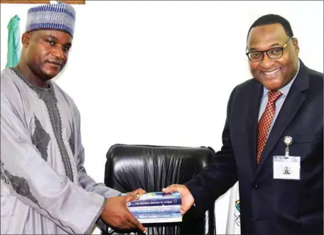  ??  ?? Dr. Musa Abubakar, Ag. Chairman, Independen­t Corrupt Practices and other Related Offences Commission (ICPC) receiving books on Maritime Seminar for Judges from Hassan Bello, Executive Secretary/CEO, Nigerian Shippers’ Council in Abuja… recently