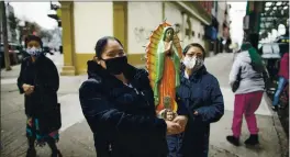  ?? EDUARDO MUNOZ ALVAREZ — THE ASSOCIATED PRESS ?? Mexican migrants carry a statue of the Virgin of Guadalupe in Brooklyn, New York.