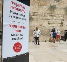  ?? (Marc Israel Sellem/The Jerusalem Post) ?? A ‘MASK REQUIRED’ sign seen situated at the Western Wall yesterday.