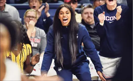  ?? Stephen Dunn / Associated Press ?? UConn’s Evina Westbrook, center, cheers for her team from the bench during a game against California last November in Storrs. Westbrook, a transfer student, was denied immediate eligibilit­y by the NCAA to play last season.