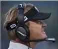  ?? JOSE CARLOS FAJARDO — BAY AREA NEWS GROUP FILE ?? Raiders head coach Jon Gruden walks the sideline while playing against the Titans at the Oakland Coliseum in Oakland last December.