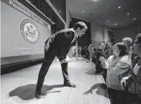  ??  ?? Rep. Scott Taylor stops to talk to constituen­ts as he leaves the stage after concluding a town hall meeting in Yorktown in 2017.