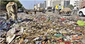  ?? PTI ?? Garbage piles up after sanitation workers continue their strike in Trilokpuri area in New Delhi on Tuesday