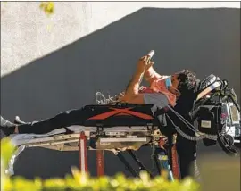  ?? Damian Dovarganes Associated Press ?? A PATIENT receives oxygen outside the emergency entrance while waiting for a room Friday at CHA Hollywood Presbyteri­an Medical Center in Los Angeles.