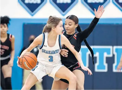  ?? TERRANCE WILLIAMS/FOR CAPITAL GAZETTE ?? South River’s Hannah Swaninger handles the ball against North County’s Na’Vaye Willis during a Dec. 17 game. As coronaviru­s continues to force teams to pause, it has started to alter the outlook of Anne Arundel County athletics.