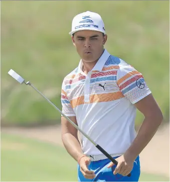  ??  ?? Rickie Fowler putts on the third green during the first round of the U.S. Open on Thursday in Erin, Wis. Fowler tied a championsh­ip record on Thursday, shooting a 7-under 65.