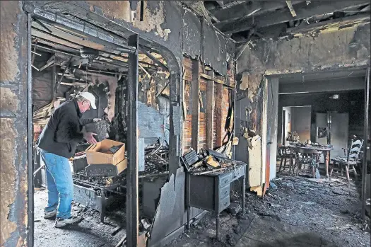  ?? ERIC ALBRECHT
DISPATCH ?? Leroy Gillam looks through the remains of his girlfriend Mahalie Moore’s home in Marion. She escaped Tuesday’s deadly fire.