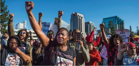  ?? HECTOR AMEZCUA/CITIZEN NEWS SERVICE PHOTO ?? Veronica Curry raises her fist with other supporters of the Black Lives Matter movement during a rally on Interstate 5 in Sacramento, Calif., on Thursday, March 22, 2018.