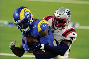  ?? AP PHOTO BY ASHLEY LANDIS ?? Los Angeles Rams running back Cam Akers, left, is tackled by New England Patriots defensive back Devin Mccourty during the first half of an NFL football game Thursday, Dec. 10, in Inglewood, Calif.