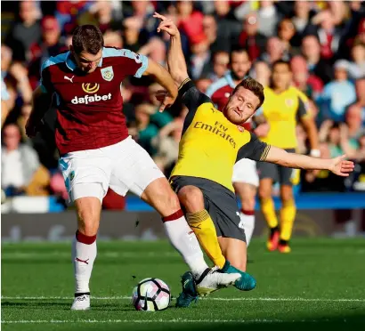  ?? Reuters ?? Burnley’s Sam Vokes in action with Arsenal’s Shkodran Mustafi during their English Premier League match on Sunday.