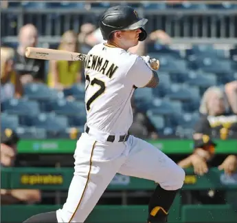  ?? Justin Berl/Getty Images ?? Kevin Newman hits the third of his record-tying four doubles in the first game Saturday at PNC Park, a two-run shot in the fifth inning that helped the Pirates beat the Brewers, 14-4.