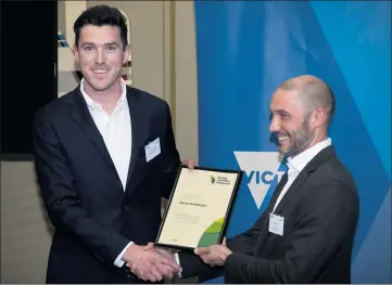  ?? ?? CONGRATULA­TIONS: Murtoa farmer Kieran Delahunty receives a $10,000 Young Farmers scholarshi­p from Agricultur­e Victoria chief executive Matt Lowe.