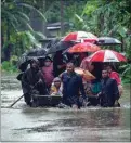  ?? ANUPAM NATH / AP ?? Indian army personnel rescue floodaffec­ted villagers on a boat in Jalimura village, west of Gauhati, India on Saturday.