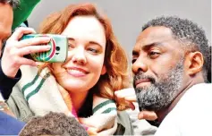  ??  ?? Elba poses for a selfie with a fan as he arrives to present ‘Yardie’ at the Berlin festival on Thursday. — AFP photos