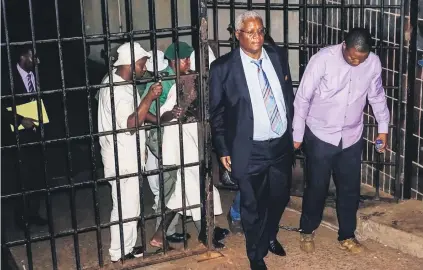  ?? Picture: AFP ?? JAILED. Zimbabwe’s former minister of finance Ignatius Chombo, second from right, leaves Harare Magistrate’s Court shackled to former Zanu-PF Youth League chairperso­n Kudzai Chipanga. Chombo is seen as an ally of Grace Mugabe.