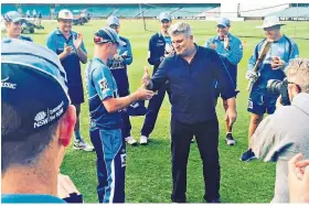  ??  ?? Boy in blue: Mason Crane receives his ‘Baggy Blue’ cap from Stuart Macgill before his New South Wales debut at the Sydney Cricket Ground in March