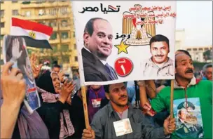  ?? MOHAMED EL-SHAHED/AFP ?? Supporters of Egyptian President Abdel Fattah al-Sisi celebrate in Cairo’s Tahrir square following his re-election for a second term, on Monday.