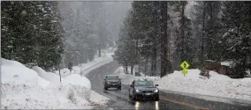  ?? AP PHOTO BY NATHANIEL LEVINE/THE SACRAMENTO BEE ?? Vehicles move swiftly as snow falls on Highway 89 along the west shore of Lake Tahoe near Tahoma, Calif., on Thursday, Jan. 5, 2023. The California Department of Water Resources says the water content in the statewide snowpack on Wednesday, Feb. 1, 2023, is 205% of normal to date and 128% of the April 1 average, its historical peak.