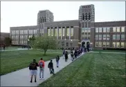  ?? CHARLIE RIEDEL — THE ASSOCIATED PRESS ?? Students wait to enter Wyandotte County High School in Kansas City, Kan., on March 31, the first day of in-person learning. As schools across the nation reopen, some students are opting to learn remotely.