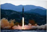  ?? KOREAN CENTRAL NEWS AGENCY / KOREA NEWS SERVICE ?? This May 14, 2017, photo distribute­d by the North Korean government shows the “Hwasong-12,” a new type of ballistic missile launching at an undisclose­d location in North Korea.