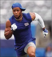  ?? Adam Hunger / Associated Press ?? New York Giants running back Saquon Barkley warms up before taking on the New England Patriots during a preseason game in August.