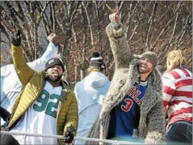  ?? GENE WALSH — DIGITAL FIRST MEDIA ?? Eagles players Fletcher Cox and Chris Long wave to fans during the team’s Victory Parade along Broad Street Thursday.