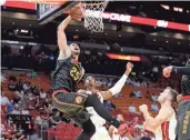  ?? / AP-Lynne Sladky ?? Atlanta Hawks’ Alex Len goes to the basket past Miami Heat’s Hassan Whiteside, center, and Goran Dragic, right, during the first half of a preseason NBA basketball game, Friday in Miami.