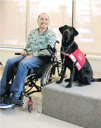  ??  ?? P.E.I. resident Jeff Poirier got his black lab guide dog, Rhyme, to help him because he suffers from a degenerati­ve neuromuscu­lar disease.