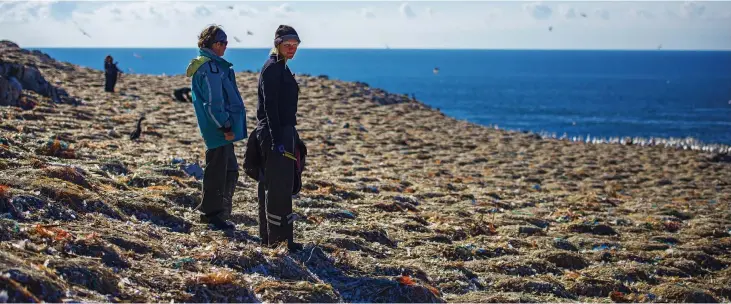  ??  ?? A deadly sea of plastic: Student volunteers Ffion Rees and Jen Tyler survey the tons of rubbish which end up on Grassholm after being thrown overboard from trawlers and cargo ships