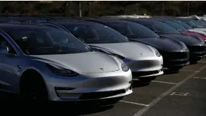  ?? (Stephen Lam/Reuters) ?? A ROW OF NEW Tesla Model 3 electric vehicles is seen at a parking lot in Richmond, California, last month.