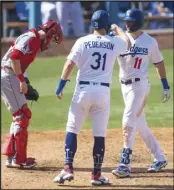  ?? Associated Press ?? NO. 1 SEED Los Angeles Dodgers’ A.J. Pollock, right, celebrates his two-run home run with Joc Pederson, center, during the seventh inning of a baseball game against the Los Angeles Angels in Los Angeles on Sunday.