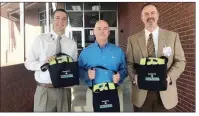  ?? SUBMITTED ?? Pottsville School District Principal Houston Townsend, center, received three new AEDs (automated external defibrilla­tors) from Conway Regional’s Billy Henry, left, and Alan Finley.