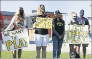  ?? STACEY WESCOTT — CHICAGO TRIBUNE VIA AP ?? University of Iowa football players parents protest outside Big Ten headquarte­rs in Rosemont, Ill., Friday, Aug. 21, 2020. Parents of Big Ten football players, upset over the process that led to the postponeme­nt of the season until spring, held a protest near the conference’s Chicagoare­a headquarte­rs Friday while an attorney in Nebraska demanded commission­er Kevin Warren turn over material illustrati­ng how the decision was made.