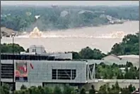  ?? Special to the Arkansas Democrat-Gazette/TONY CASSADY ?? Water spouts more than 30 feet into the air Sunday morning on both sides of the flooded Arkansas River after a natural gas pipeline ruptured.